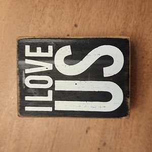 Distressed sign on wood, "I love us"